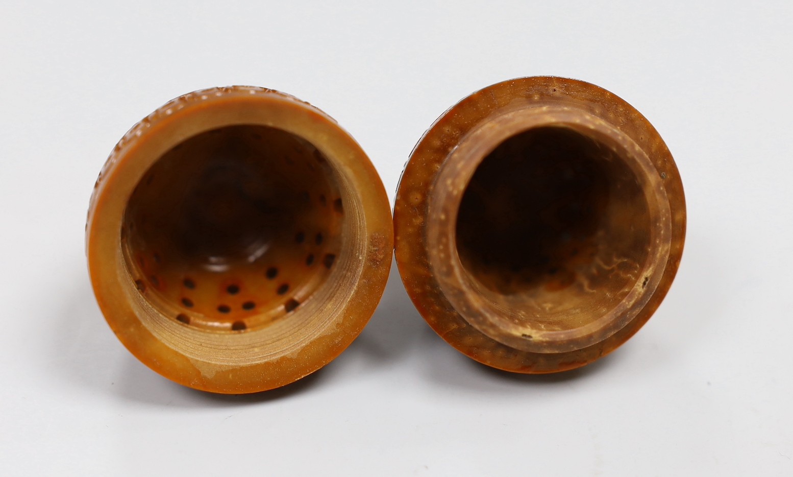 Five Chinese peach stone carvings, largest 4.2cm and a coquilla nut egg shaped box